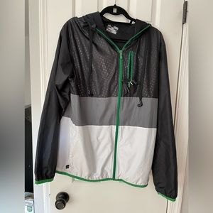 NWOT mens under Armour green, black and white loose wind breaker, sized medium